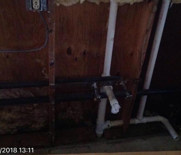 Exposed pipes with mold growth.